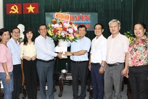 市委民运处副主任陈春田（左三）向本报主编阮玉英赠送鲜花。