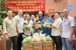 左闾天后圣母庙各理事向穷人派发礼品。