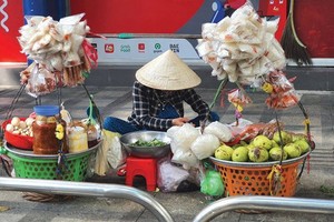 小贩在人行道、马路上摆放货物。