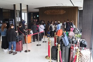 外国游客等待办理入住。（图：韩联社）