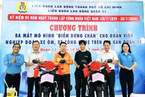 诸位领导和庆云南院住持周华邦（右二）向劳动者赠送摩托车。