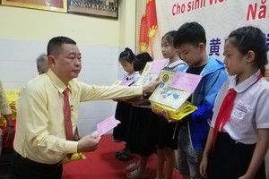 黄氏宗祠理事长黄锦雄向优秀小学生颁奖。