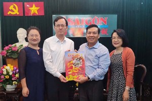《西贡解放报》副总编辑、本报主编阮玉英(红蓝)向中国驻胡志明市代表团赠送春刊。