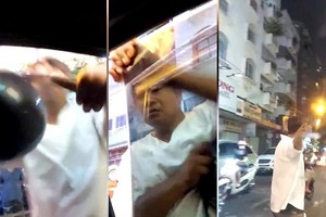 摄像机记录了一名男性在黎鸿峰街上截停一辆汽车并砸毁该车的左侧挡风玻璃，同时还袭击了司机。（图：视频截图）