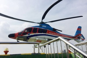 A helicopter lands on the top of Times Square building, Nguyen Hue street, downtown HCMC