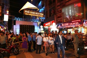 Visitors at Bui Vien walking street which was officially opened in HCMC on August 20 (Photo: SGGP)