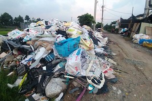Industrial waste sneakily dumped in a road in Vinh Loc A commune, Binh Chanh district