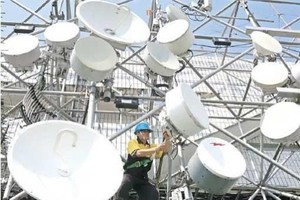 A technician carries out maintenance work at one of Indosat Ooredoo's base transceiver stations (BTS) in Jakarta. (Source: Jakarta Post)