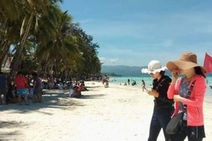 Tourists on a Philippine beach (Source: https://www.pna.gov.ph)