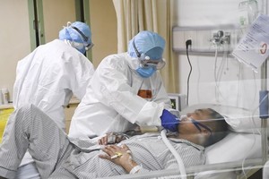 Medical workers care for an nCoV-infected patient at a hospital in Chongqing city of China on February 1 (Photo: Xinhua/VNA)