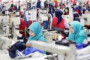 Workers operate sewing machines at a garment factory in Bogor, West Java. (Photo: Antara)