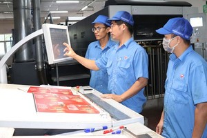 Workers mastering advanced printer technology