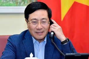 Deputy Prime Minister and Foreign Minister Pham Binh Minh during a phone call with Singaporean Foreign Minister Vivian Balakrishnan. Photo courtesy of the Ministry of Foreign Affairs.