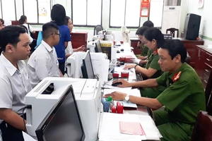 Các cán bộ PC64 Công an TPHCM đang tiếp nhận hồ sơ làm căn cước công dân 