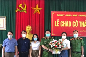 Lãnh đạo Công an huyện Kỳ Anh và xã Kỳ Bắc tặng hoa khen thưởng chị Thiều Thị Ba. Ảnh: Công an huyện Kỳ Anh cung cấp