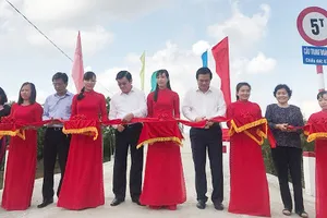 Các đại biểu thực hiện nghi thức cắt băng khánh thành cây cầu mới
