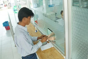 Bệnh nhân nhận thuốc ARV thông qua Quỹ BHYT chi trả tại Trung tâm Y tế huyện Bình Chánh vào sáng 8-3