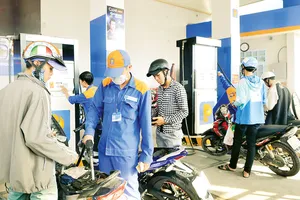  Người dân đổ xăng E5 RON92 tại một điểm bán xăng dầu ở TPHCM Ảnh: Cao Thăng