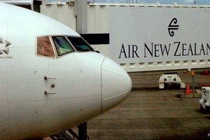 An Air New Zealand Boeing 737 sits at a departure gate at Auckland Airport, Auckland. —AFP/VNA Photo