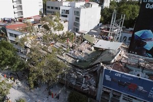 View of buildings flattened by a powerful quake in Mexico City on September 19. A devastating quake in Mexico on Tuesday killed more than 100 people, according to official tallies, with a preliminary 30 deaths recorded in the capital where rescue efforts 