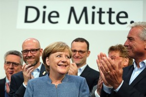German sitting Chancellor Angela Merkel (L, Front) is applauded after the preliminary exit poll at the Christian Democratic Union (CDU) party’s headquarters in Berlin, Germany, on Sunday