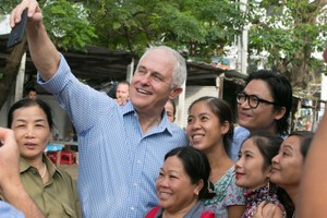 Australian Prime Minister Malcolm Turnbull takes a selfie with local residents in Danang