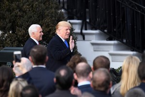 US President Donald Trump (R, rear) and Vice President Mike Pence (L, rear) arrive at an event celebrating the passage of the tax bill on the South Lawn of the White House in Washington DC, the US, on Wednesday.