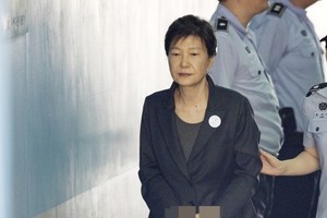 Court sentences ex-leader Park to 8 years in prison...