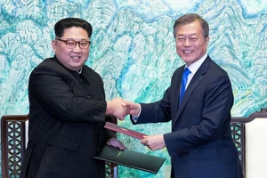 Chủ tịch Kim Jong Un và Tổng thống Moon Jae In ký văn bản sau hội đàm ngày 27-4. Ảnh: REUTERS