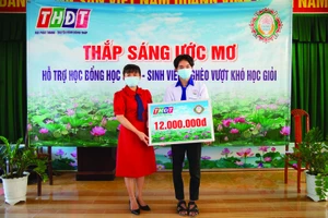 Bà Đặng Thị Ngọc Hiền, Giám đốc Công ty Xổ số Kiến thiết Đồng Tháp trao học bổng cho em Tú