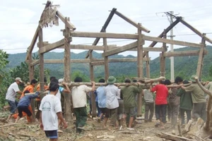 Người dân cùng nhau dựng lại nhà trong lũ ở Ngư Hóa, Tuyên Hóa, Quảng Bình. Ảnh: MINH PHONG