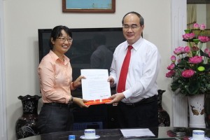 市委書記阮善仁頒發市委常務處的《決定》，調任陳氏妙翠同志從舊邑郡郡委至市勞動聯團工作