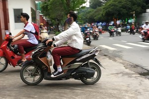 學生騎車不戴安全帽。