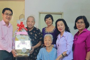 第十坊人民議會主席武氏芳蓉（右二）和人委會主席吳江煌欣（左） 向當地民眾問候。