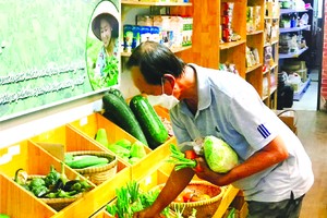 顧客在“家鄉市集”綠色產品商店購買蔬菜。