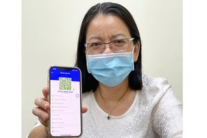Deputy Director of the HCMC Department of Information and Communication Vo Thi Trung Trinh with her individual QR code on ‘Y te HCM’ app.
