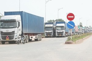 Cargo trucks are waiting for customs clearance procedure at Bac Luan 2 Border Gate