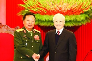 General Secretary of the Communist Party of Vietnam (CPV) Central Committee Nguyen Phu Trong is greeting Deputy Prime Minister and Defence Minister of Laos Chansamone Chanyalath