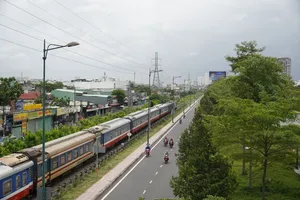 The North-South train is moving on the railway parallel to Kha Van Can Street in Thu Duc City of HCMC (Photo: SGGP)