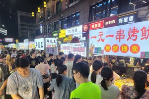 Tourists are in line to buy delicacies