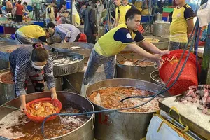 Traders at Binh Dien Wholesale Market are busily preparing seafood for overnight delivery to customers (Photo: SGGP)