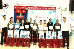 Leaders of HCMC Social Security award health insurance cards to disadvantaged residents in the city