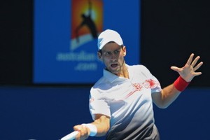 Djokovic feels the heat but passes test