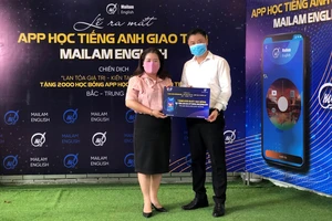 Đại diện Tỉnh Đoàn Đồng Nai (bên trái) nhận biểu trưng 200 suất học bổng tại lễ ra mắt ứng dụng