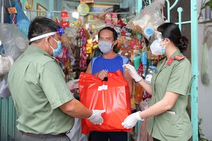 Công an quận 4, TPHCM tặng quà cho người nghèo bị ảnh hưởng bởi dịch Covid-19. Ảnh: DŨNG PHƯƠNG