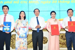 Bí thư Thành ủy TPHCM Nguyễn Văn Nên trao quyết định đến các cá nhân. Ảnh: VIỆT DŨNG