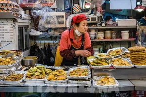 Người dân bán thực phẩm tại khu chợ Gwangjang ở Seoul, Hàn Quốc. Ảnh: AFP/TTXVN