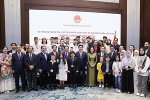 国家主席梁强和夫人与旅埃越南人社群代表合影。