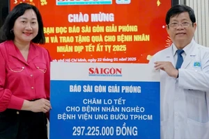 Bà Bùi Thị Hồng Sương - Phó Tổng Biên tập Báo Sài Gòn Giải Phóng trao bảng tượng trưng cho TS.BS. Diệp Bảo Tuấn - Giám đốc Bệnh viện Ung Bướu TP. Hồ Chí Minh. Ảnh : VIỆT NGA