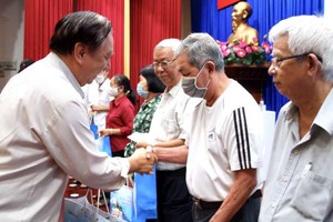 第十一郡高齡人會主任朱杞文向對革命有功的模範高齡者贈送禮物。